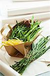 Various types of beans in a paper bag and next to it