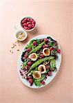 Mixed leaf salad with avocado, raspberries, goat's cheese and pine nuts