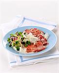 Tagliata di cotechino (raw sausage meat with shaved Parmesan, Italy)