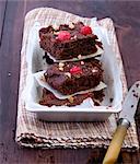 A stack of raspberry brownies with nuts