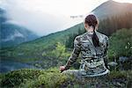 Woman meditating in mountains