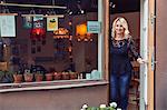 Woman standing in shop door