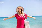 Happy blonde woman arriving at the beach