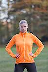 Portrait of a pretty blonde woman doing sport in park looking at camera