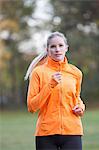 Pretty blonde woman doing jogging in park