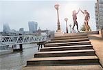 Runners high-fiving on sunny urban steps