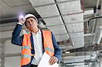 Foreman with flashlight at construction worker