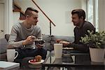 Gay couple having breakfast together at home