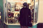 Rear-view of woman looking at jewelry counter in the supermarket