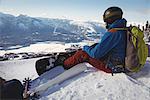 Skier relaxing on snow landscape during winter