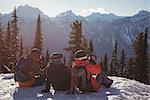 Three skiers relaxing on snow mountain during winter