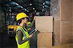 Female worker using digital tablet while working in warehouse
