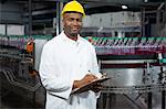 Portrait of smiling male worker noting about products in warehouse