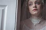 Close-up of young bridal wearing birdcage veil in a boutique