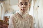 Portrait of young bride relaxing on sofa in a boutique