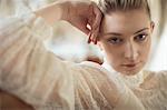 Portrait of young bride relaxing on sofa in a boutique