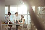 Group of executives discussing over digital tablet at office