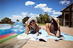 Beautiful women reading book while sunbathing on a sunny day