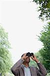 Man looking through binoculars