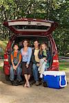 Family sitting in back of car