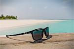 Close up sunglasses on sunny tropical beach