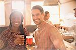 Portrait smiling couple drinking beer in bar