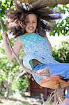 Portrait of young girl on rope swing