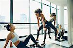 Two young women in gym, taking a break from workout