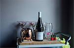 Drinks trolley with wine bottle, glasses and tankards