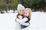 Sisters in snow-covered park, Oshawa, Canada