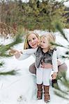 Mother and daughter in snow-covered park, Oshawa, Canada