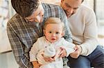 Portrait cute baby son with male gay parents