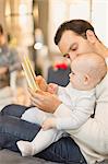 Father reading book to cute baby son