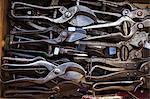 Overhead view of a box of old rusty worn metal shears, tin snips and pliers in a workshop.