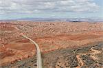 Comb Ridge is in Bears Ears National Monument view over the desert and a road through the plain.