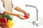 Japanese woman washing vegetables in the kitchen