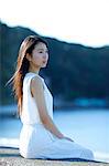 Young Japanese woman in a white dress by the sea, Chiba, Japan