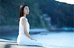 Young Japanese woman in a white dress by the sea, Chiba, Japan