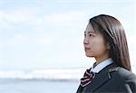 Young Japanese woman in a high school uniform by the sea, Chiba, Japan