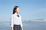 Young Japanese woman in a high school uniform by the sea, Chiba, Japan