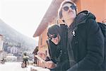 Couple using smartphone touchscreen, Monte San Primo, Italy