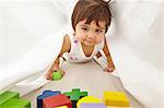 Portrait of toddler, crawling between sheets