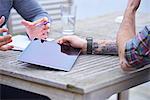 Cropped shot of male design team using digital tablet outside design studio