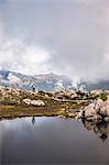 Hiker by lake on Mount Baker, Washington, USA