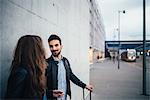 Couple by grey wall background, Florence, Italy