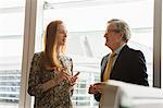 Businessman and businesswoman having discussion