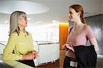 Businesswomen talking in reception area of office