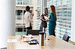 Businesswomen talking in meeting room, London, UK