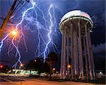 Spectacular lightning bolt with simultaneous branches strikes Cocoa, Florida, amid power lines near the city's water tower