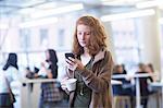 Student using mobile phone in library